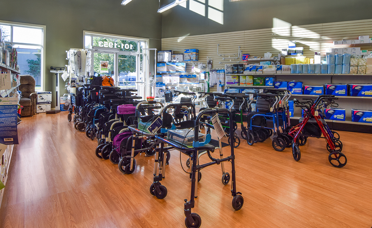 A store interior displaying various mobility aids, including several walkers, with medical supplies on shelves in the background.