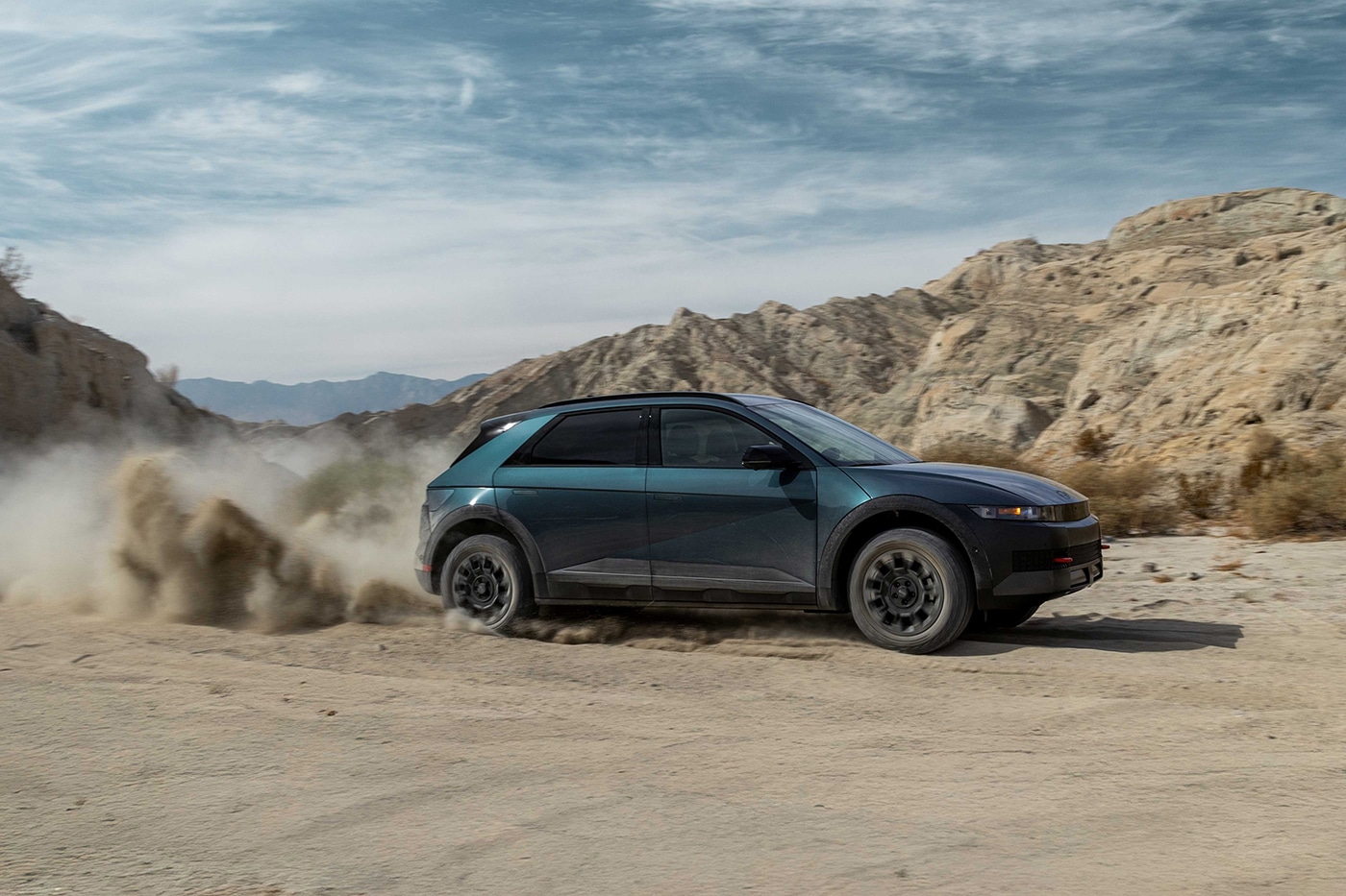 Electric SUV kicking up dust in desert terrain, featured by Penticton Marketing Agency for auto dealer marketing