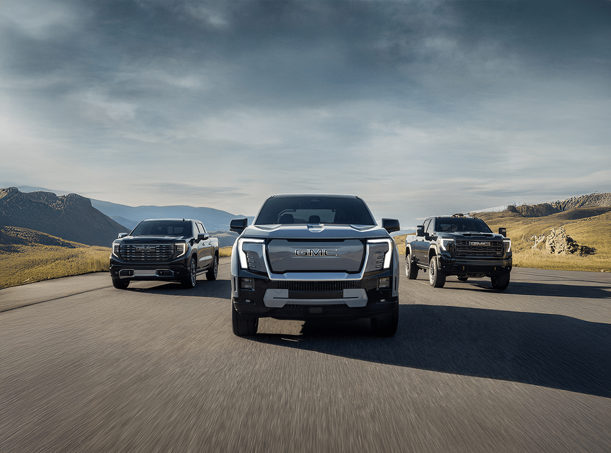 Auto dealership marketing campaign in Marketing Kelowna showcasing GMC trucks driving on an open road to attract buyers and boost sales