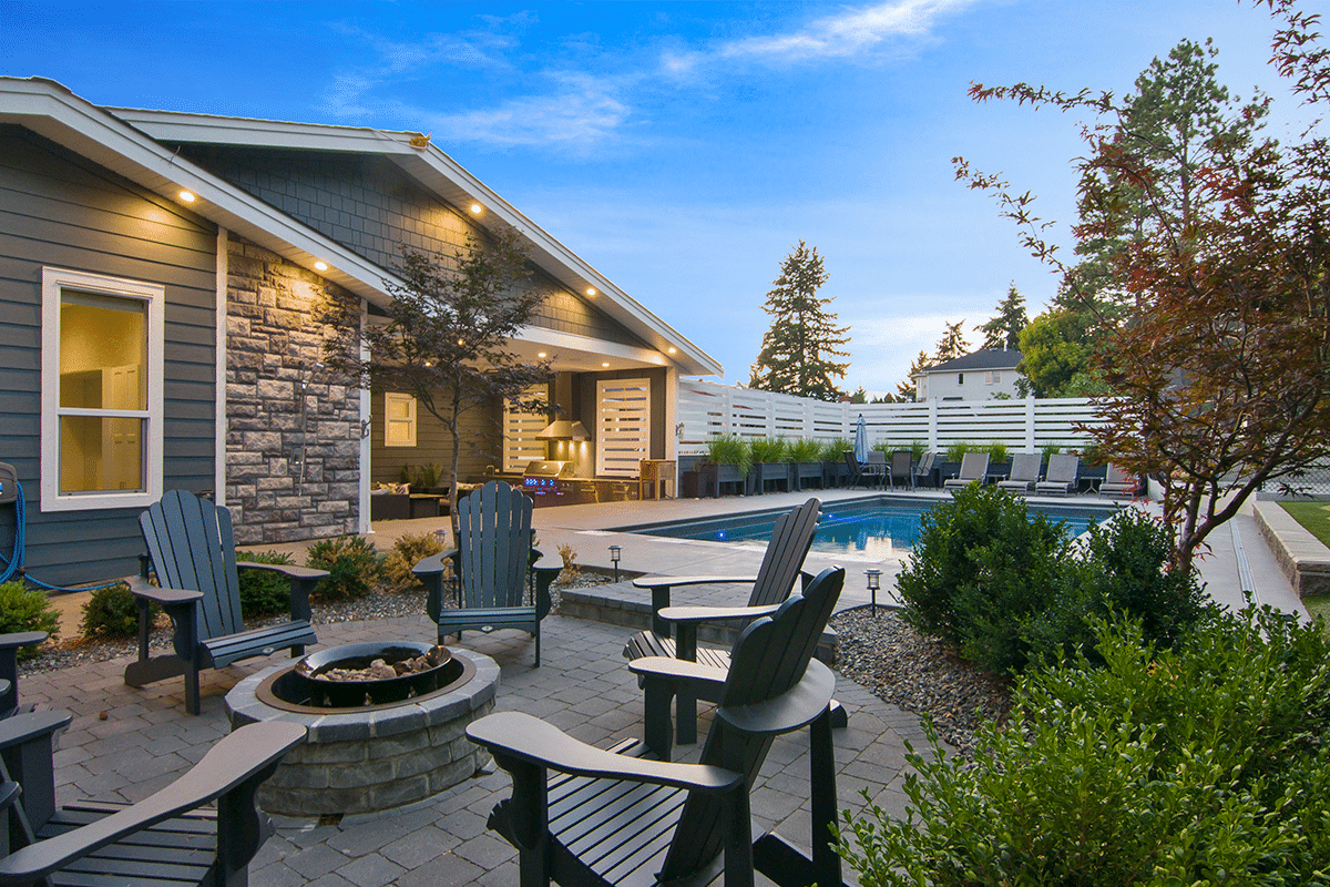Beautiful real estate property with outdoor seating and pool featured in Marketing Kelowna strategies for attracting buyers and maximizing sales.